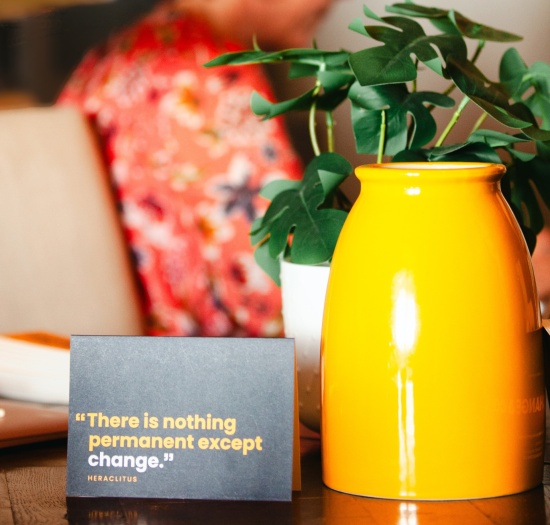 There is nothing permanent except change Heraclitus quote card sitting on table next to yellow vase